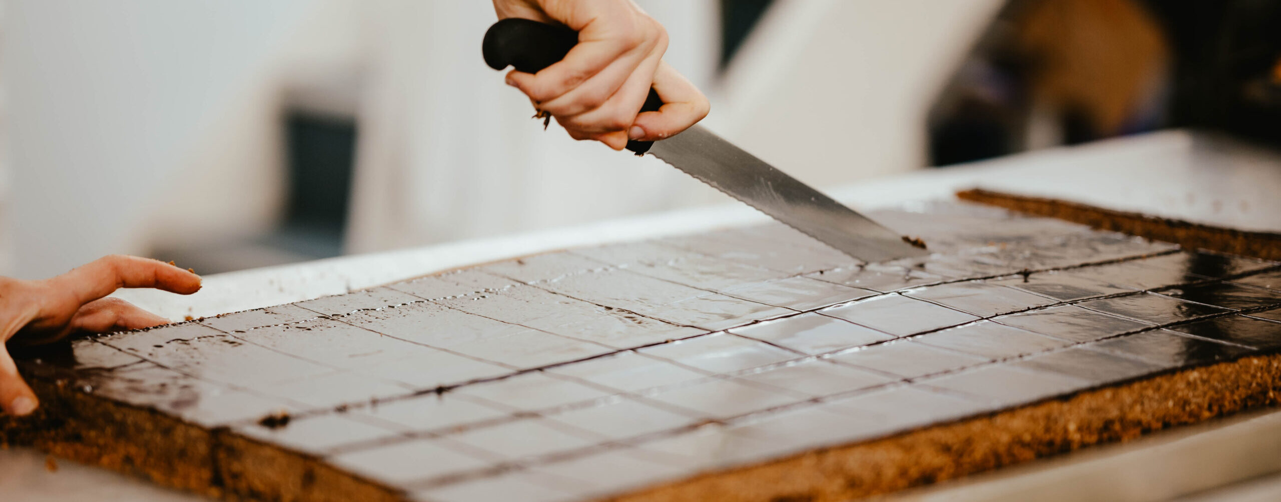 Slicing a fresh chocolatey tray bake